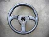 The steering wheel attached to the spacer. Notice how it sits off center of the hub adapter now.