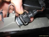 Squeeze the clip then pull off the connector.