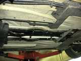 Closeup of the hoses that run down the middle of the car that are otherwise hidden.